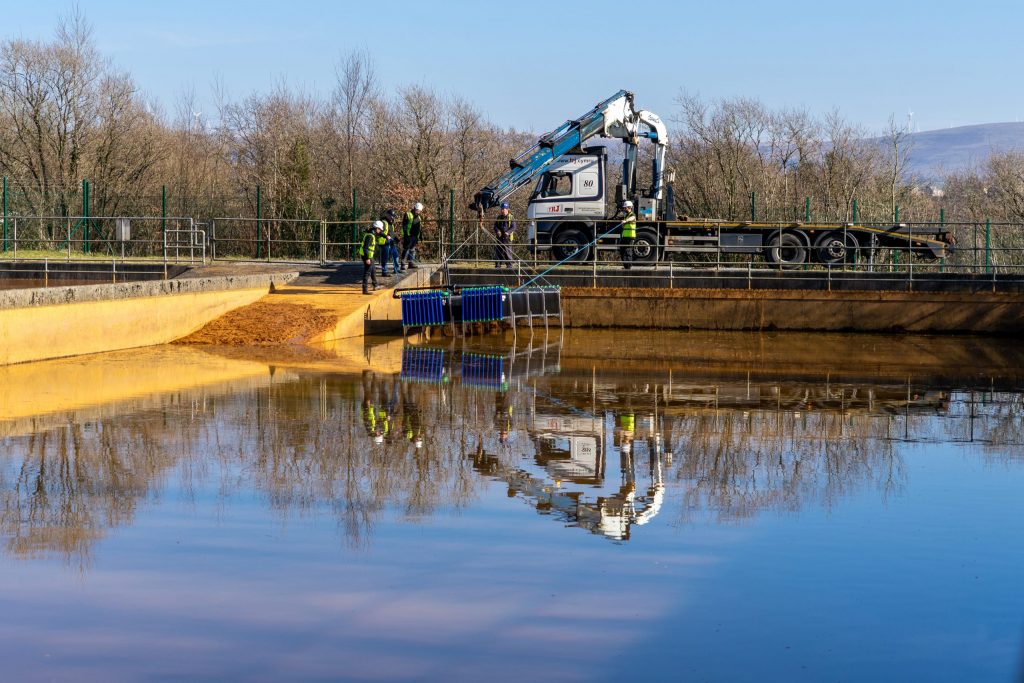 Heat exchangers being installed into the treatment lagoons at Lindsay, Wales